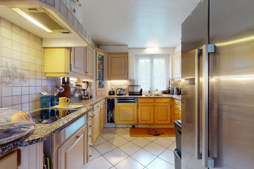 kitchen featuring black electric stovetop, dishwasher, tasteful backsplash, light tile patterned floors, and stainless steel fridge