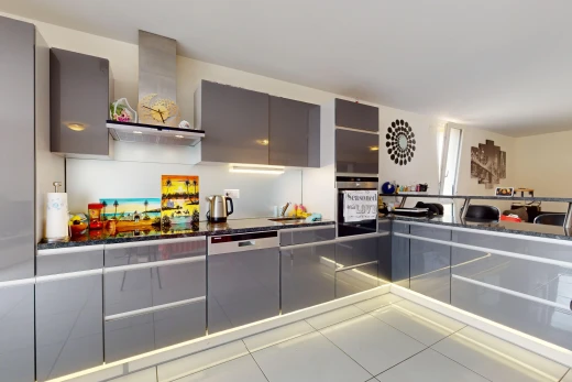 kitchen featuring gray cabinets, wall chimney exhaust hood, stainless steel appliances, and tile patterned floors