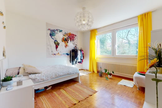 chambre à coucher avec parquet, lumière naturelle, et radiateur