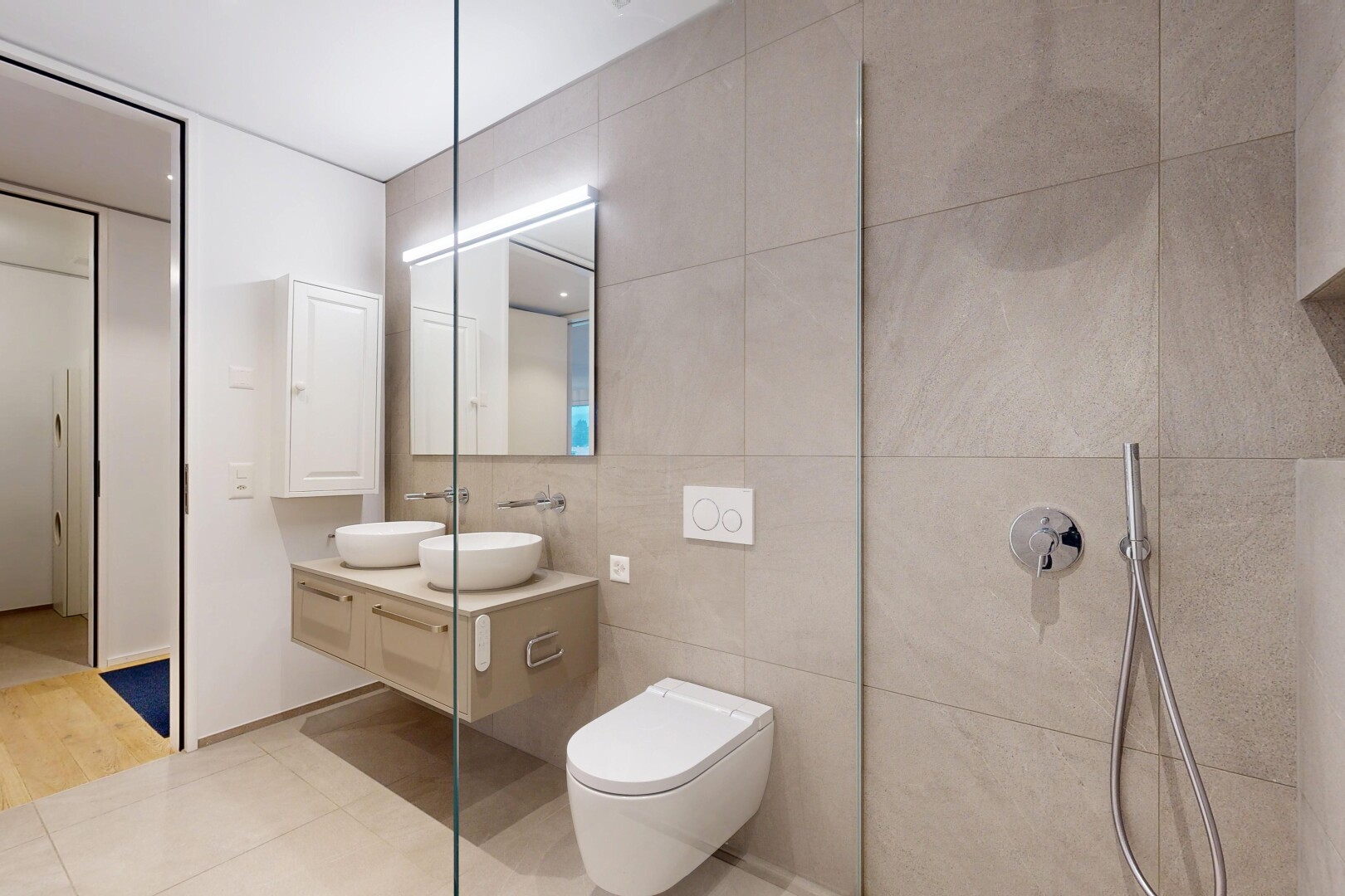 full bath with double vanity, tile walls, tile patterned flooring, and walk in shower