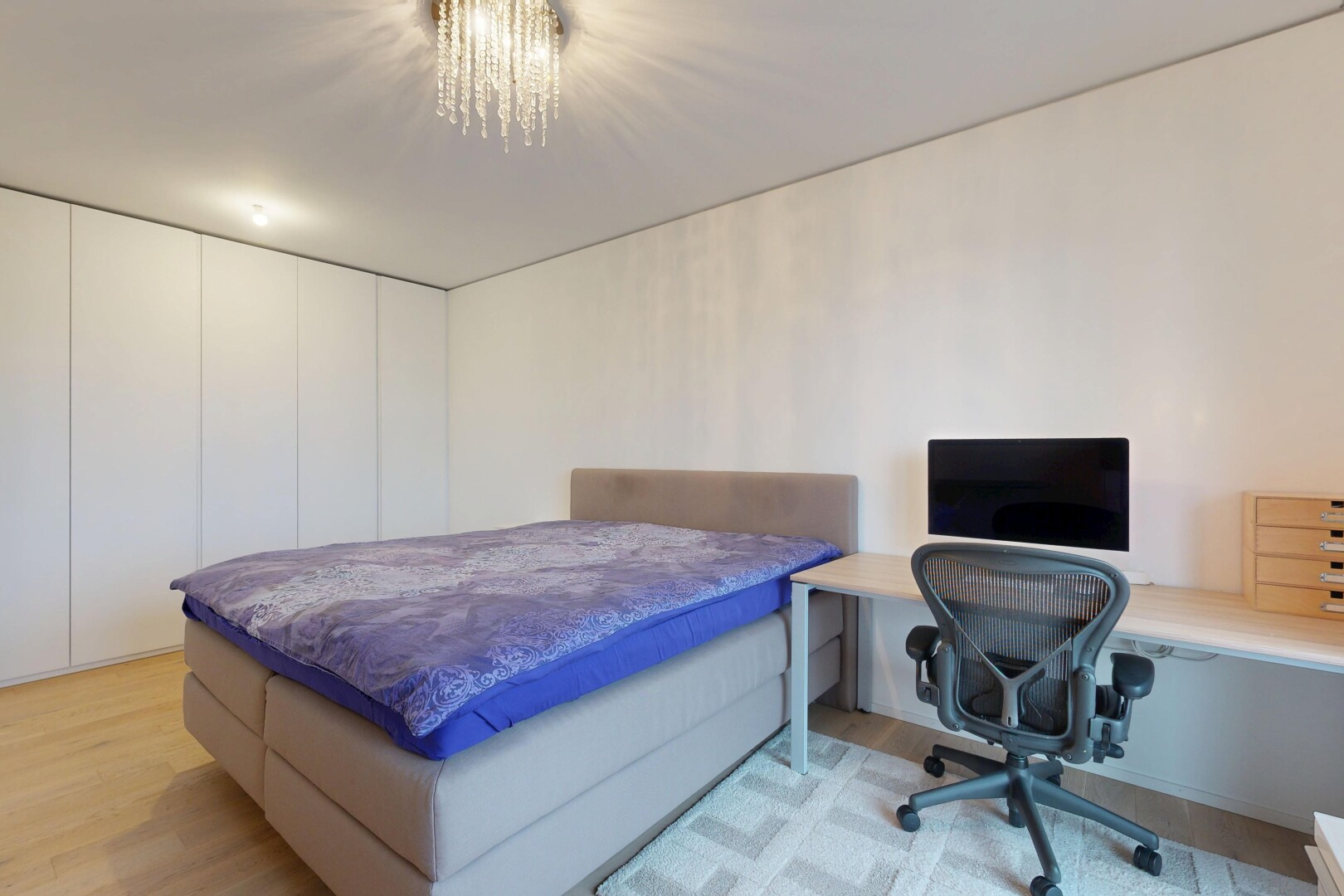 room / bedroom featuring light wood-style flooring, a desk, and suspended lighting