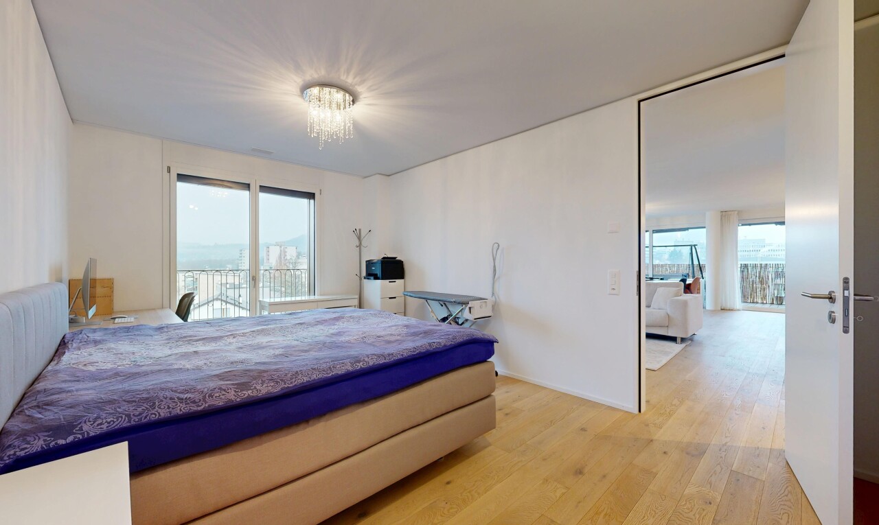 room with light wood-style flooring, access to outside, and a chandelier