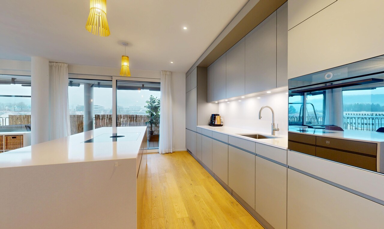 kitchen featuring gray cabinetry, modern cabinets, light wood-type flooring, oven, and hanging light fixtures