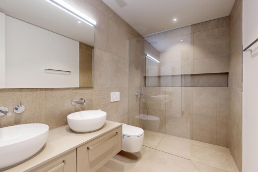 bathroom featuring a walk in shower, double vanity, tile walls, recessed lighting, and light tile patterned floors