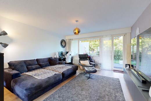 living area featuring decorative light fixtures, a desk, and wood finished floors