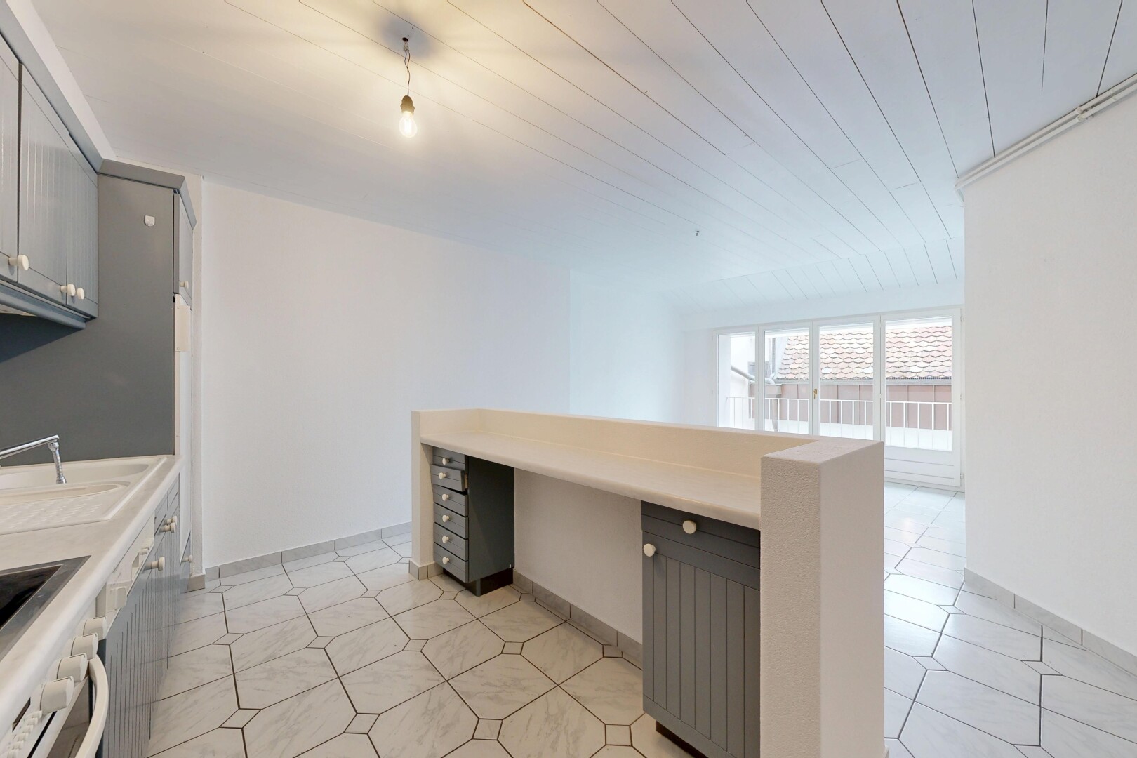 kitchen with gray cabinetry, light countertops, built in study area, wooden ceiling, and oven