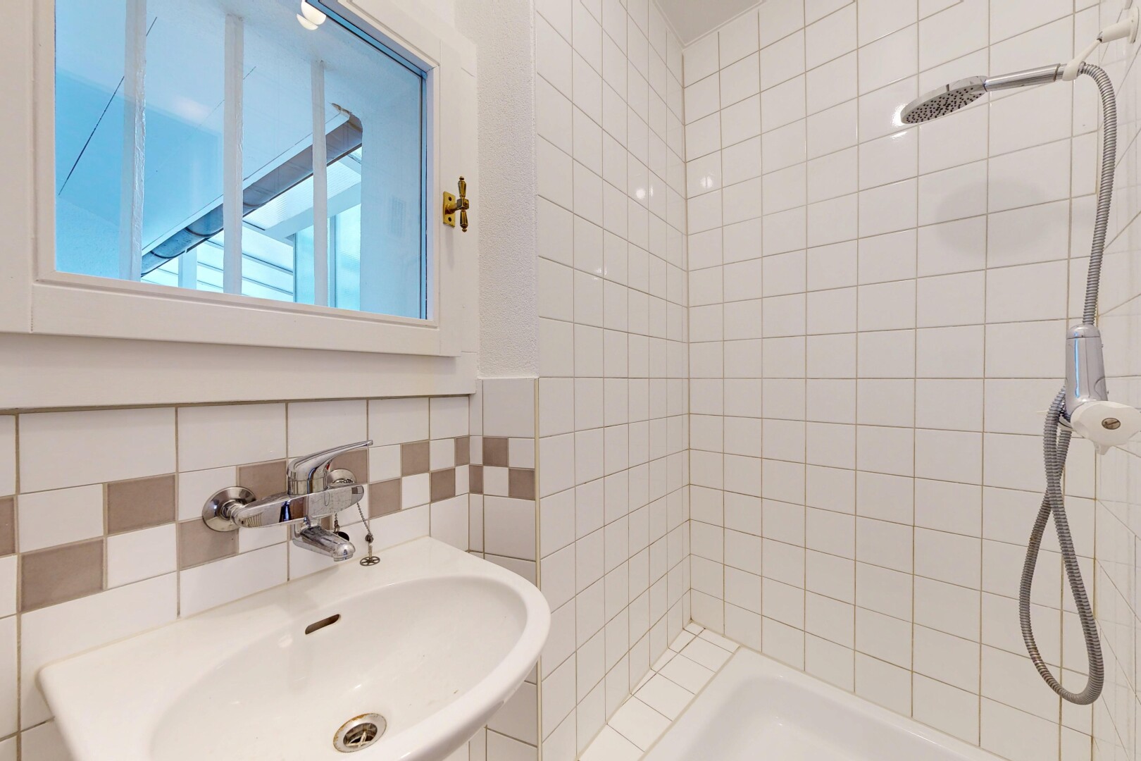 bathroom with a tile shower and tile walls