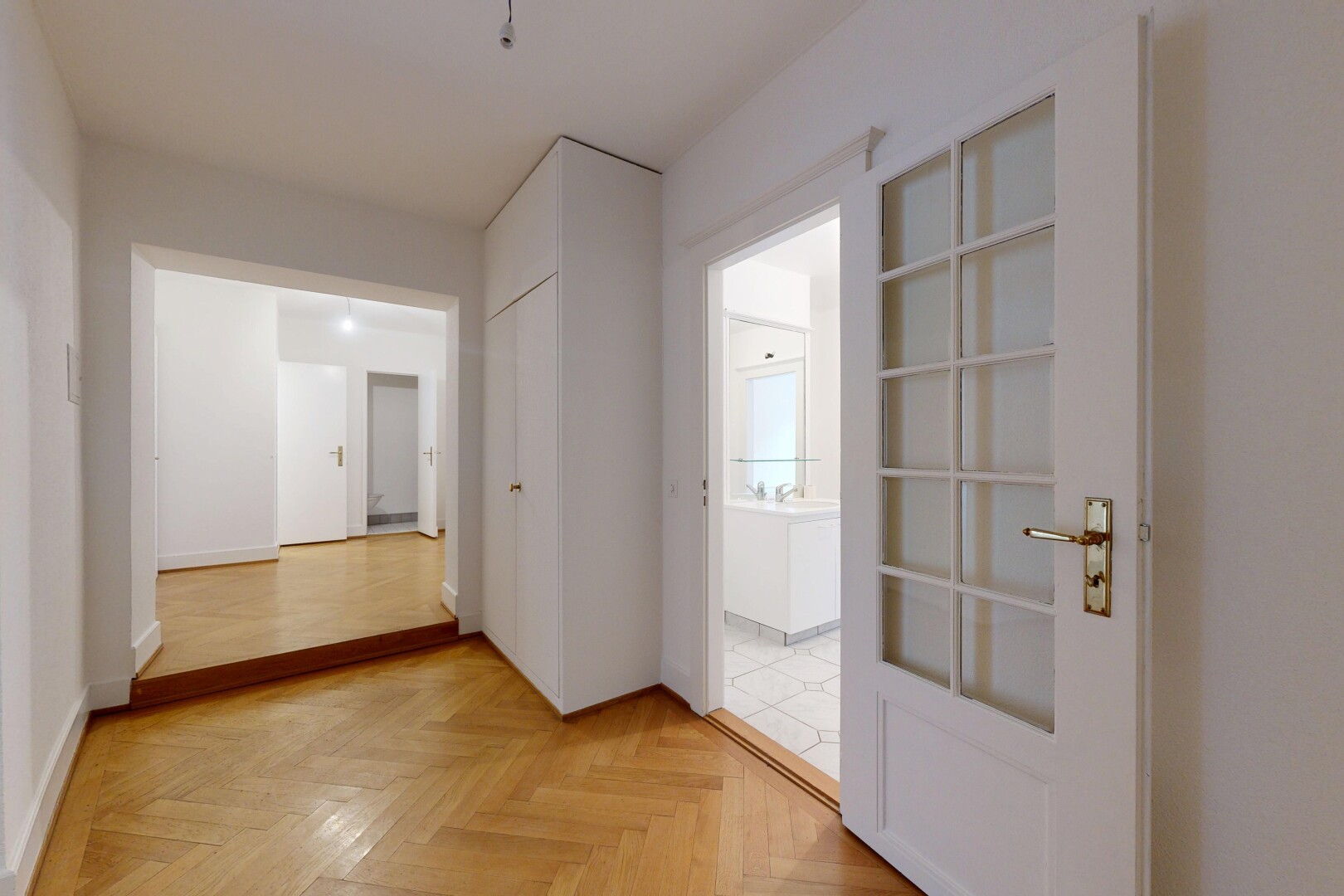 corridor with parquet flooring and baseboards