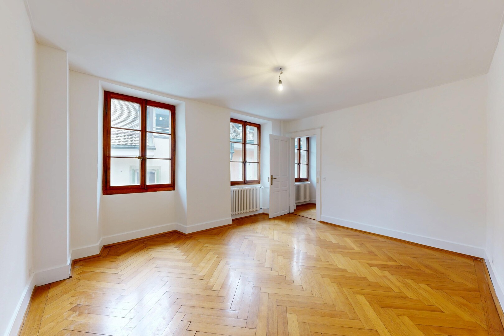 unfurnished room featuring parquet floors and radiator