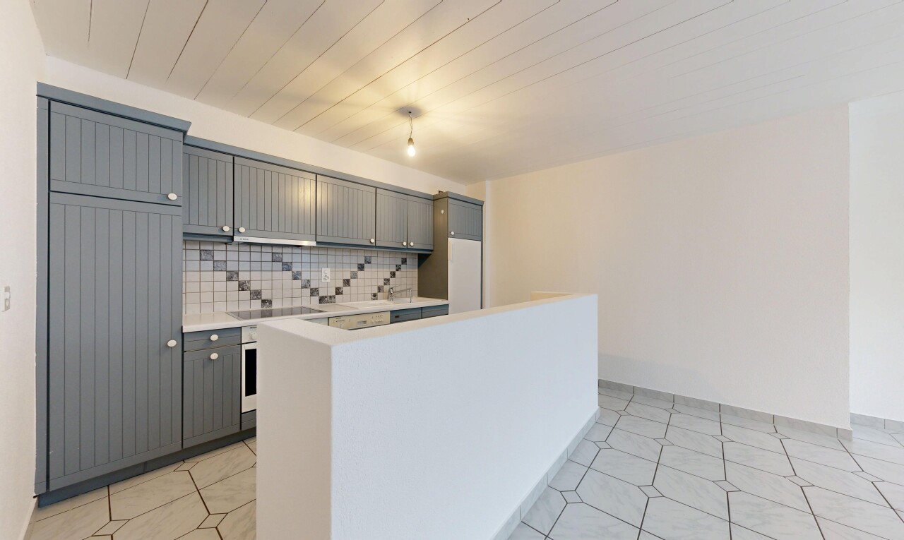 kitchen featuring gray cabinets, backsplash, a center island, oven, and black electric stovetop