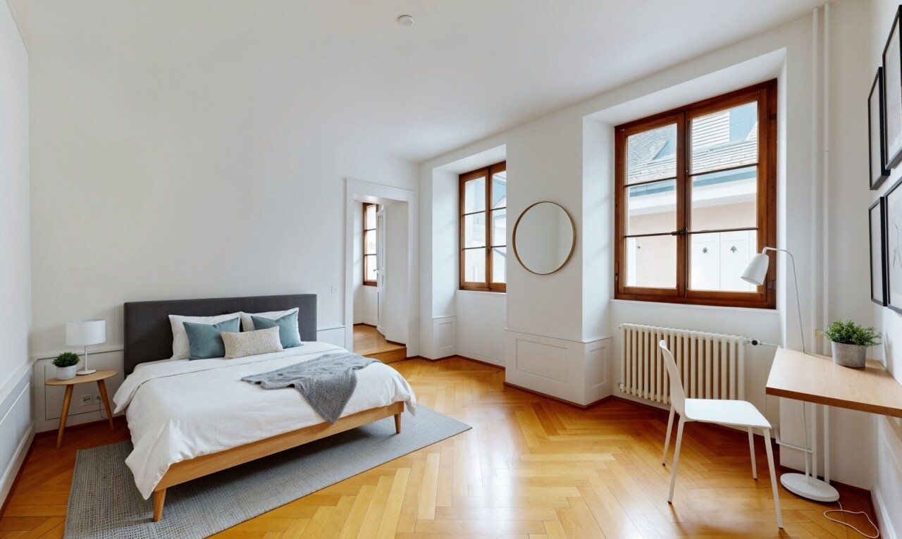 spare room with radiator heating unit, wainscoting, parquet floors, and a decorative wall