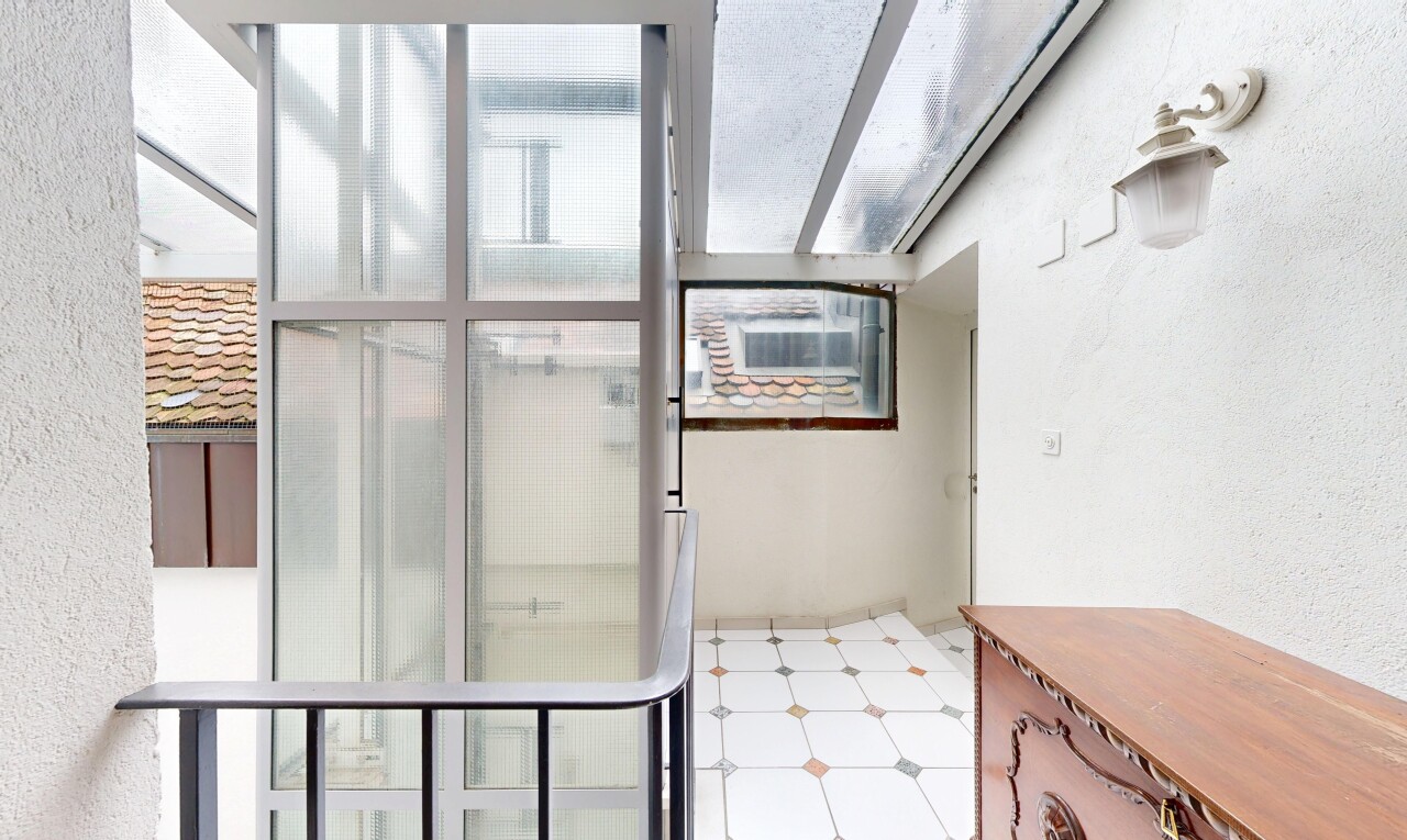 patio / terrace featuring a sunroom