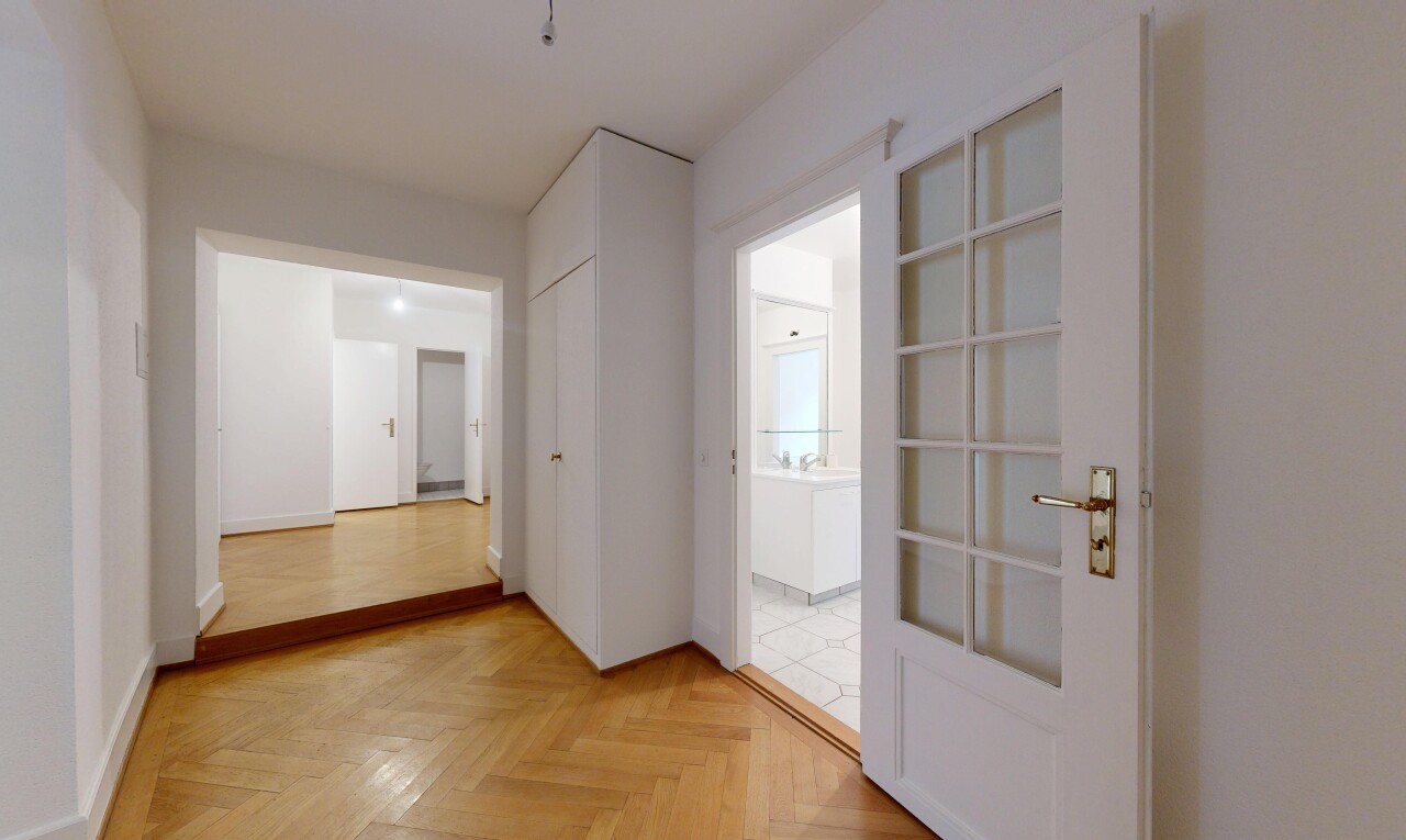corridor with parquet flooring and baseboards