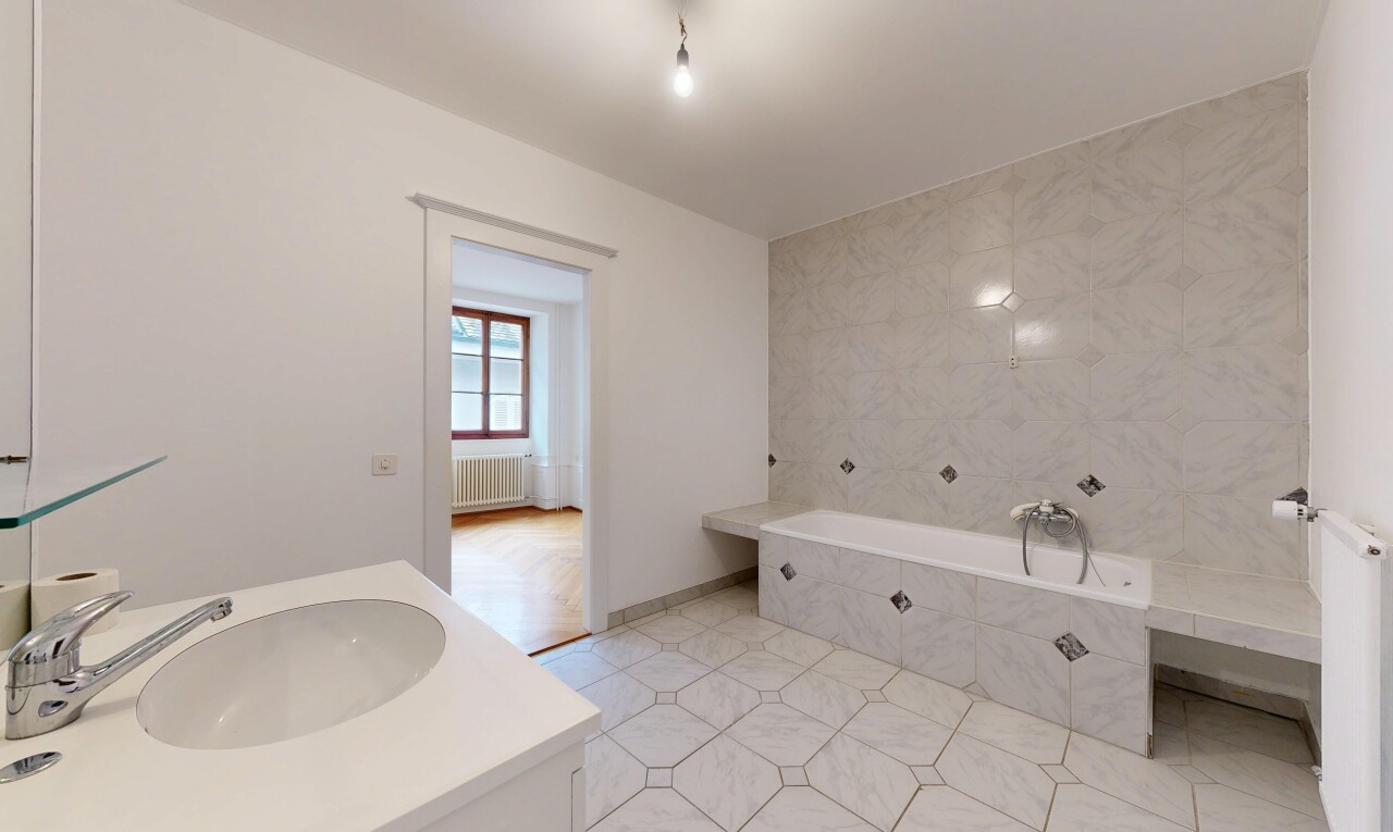 full bath with vanity, a garden tub, radiator heating unit, and light tile patterned floors