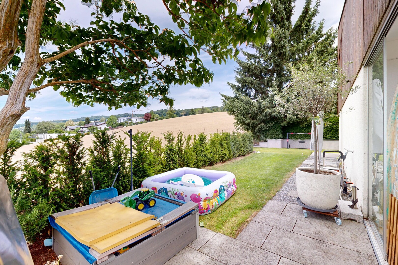 garden featuring a patio, a yard, and an outdoor hot tub