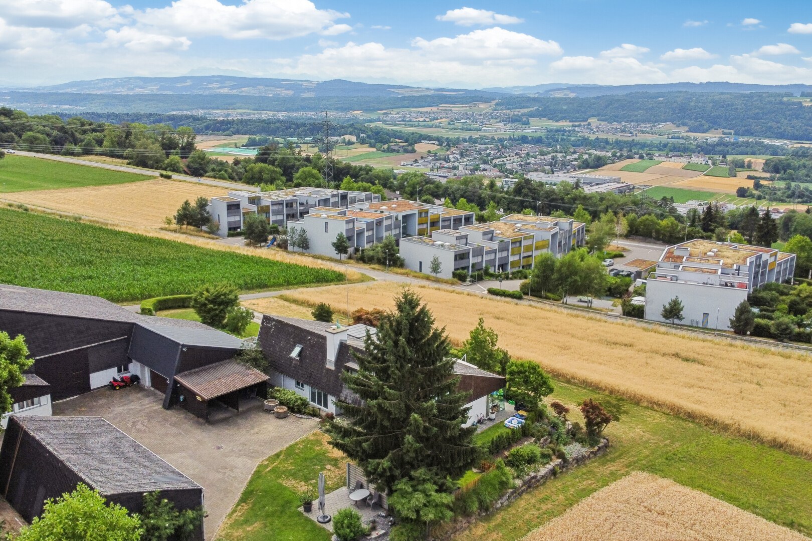 view of mountain backdrop featuring rows of crops and rural landscape