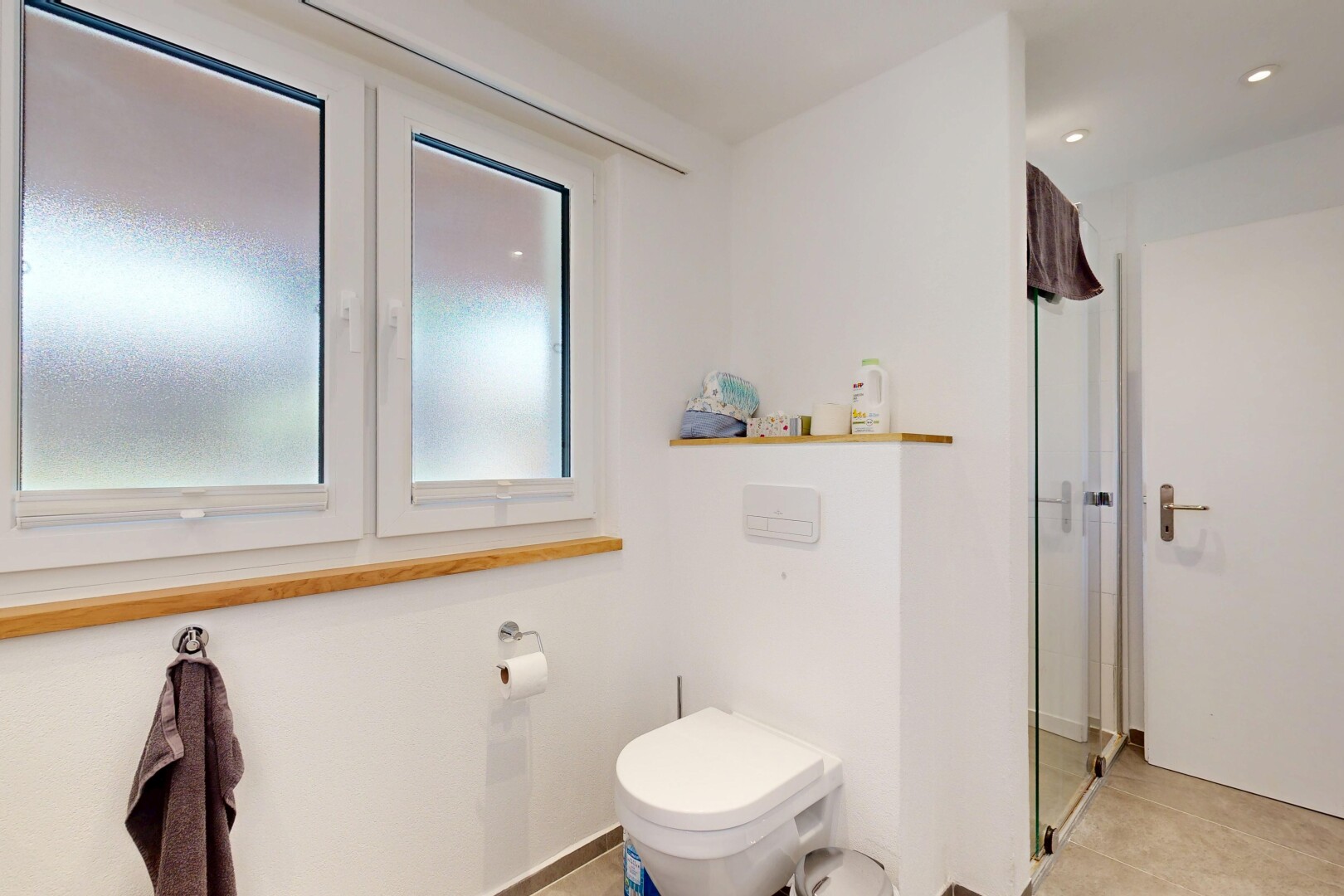 bathroom with a stall shower and recessed lighting