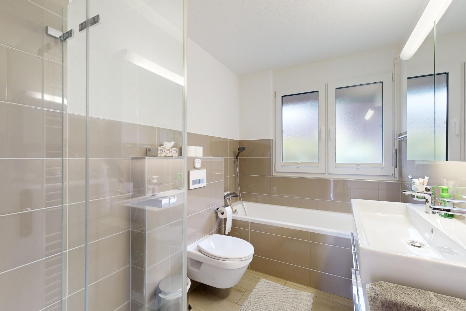 bathroom with vanity, a garden tub, tile walls, and tiled shower