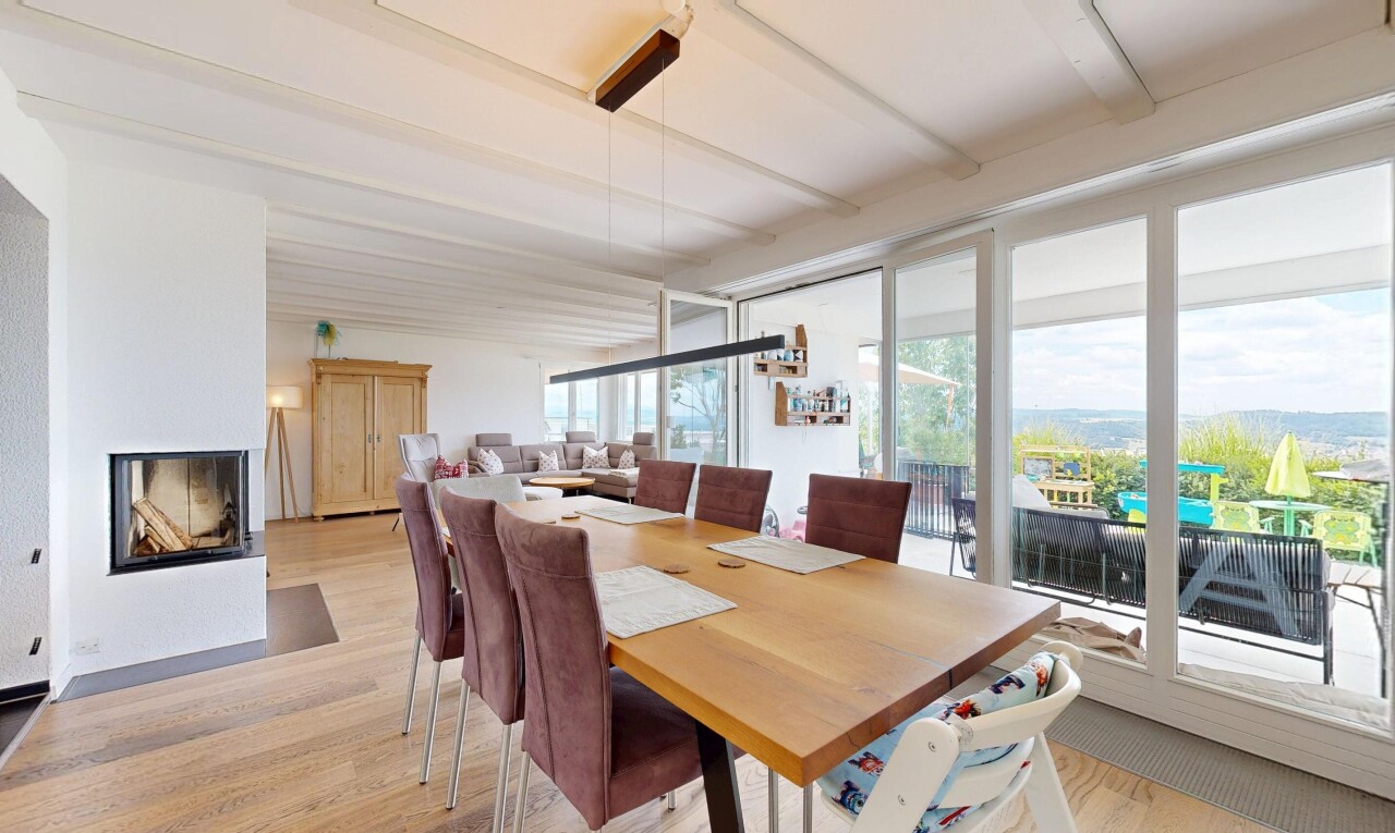 dining room with light wood finished floors and a multi sided fireplace