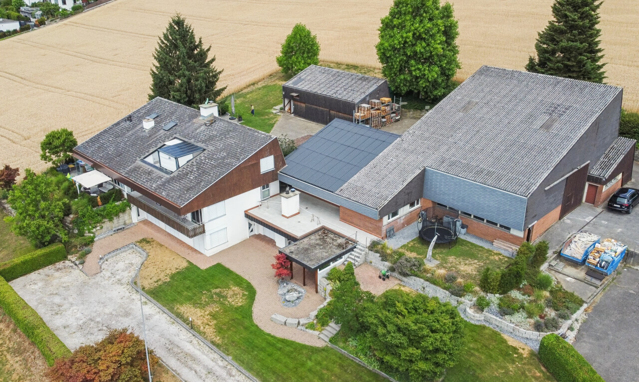 outdoor house featuring driveway and solar panels