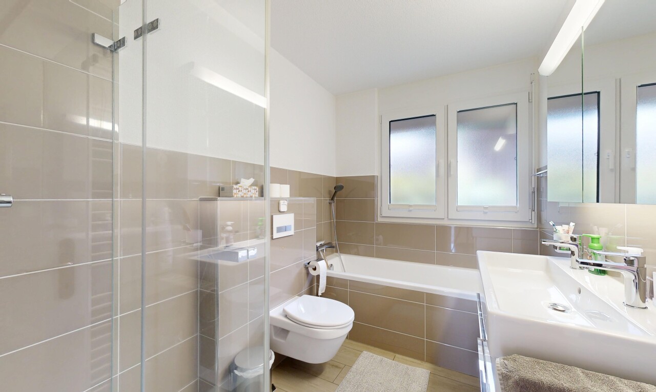 bathroom with vanity, a garden tub, tile walls, and tiled shower
