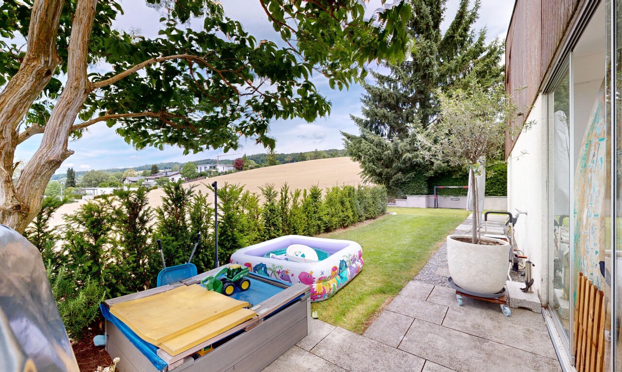 garden featuring a patio, a yard, and an outdoor hot tub