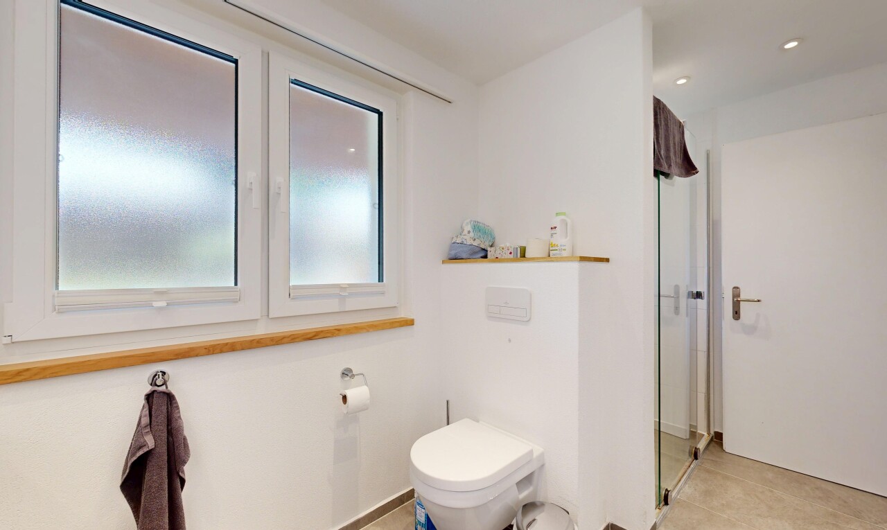bathroom with a stall shower and recessed lighting