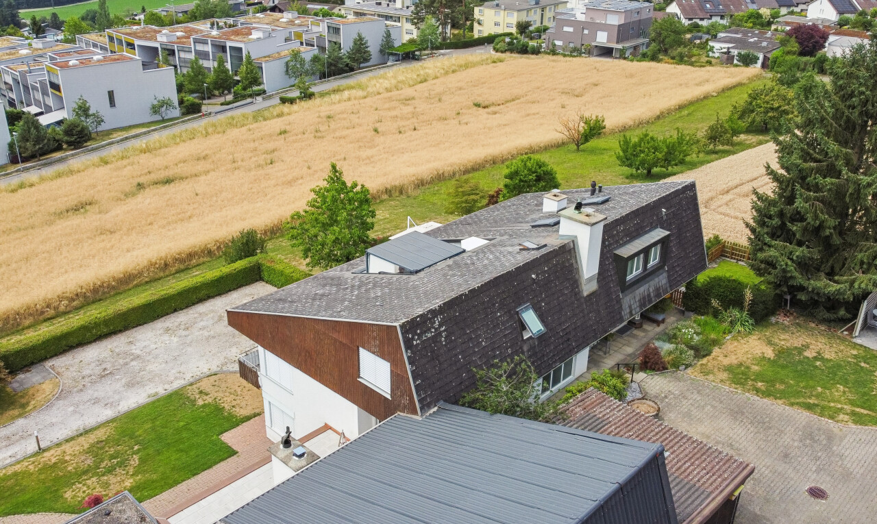 view of property featuring roof mounted solar panels