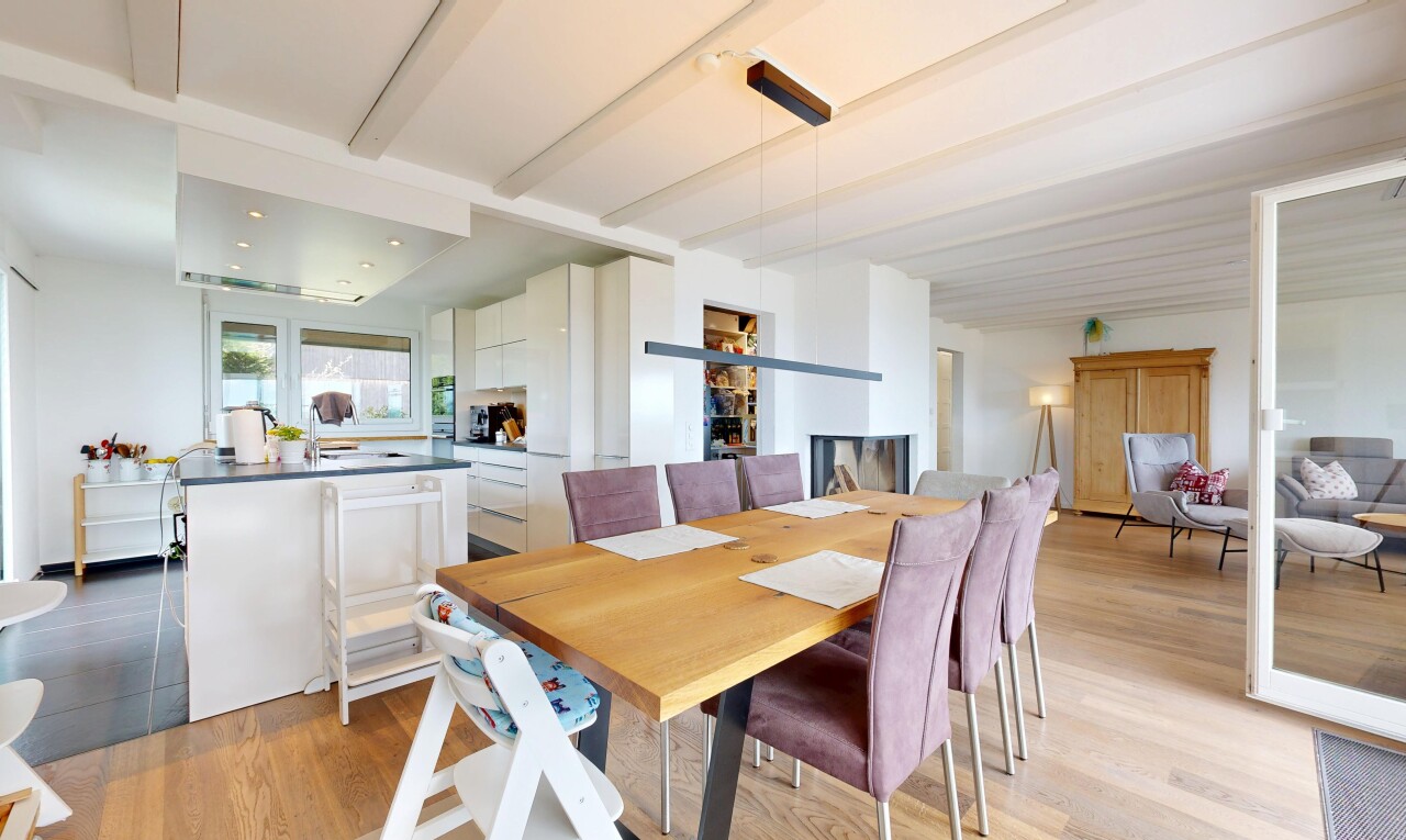 dining room with beamed ceiling and light wood-type flooring