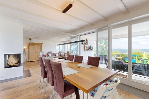 dining room with light wood finished floors and a multi sided fireplace