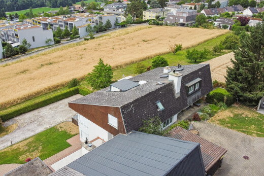 view of property featuring roof mounted solar panels