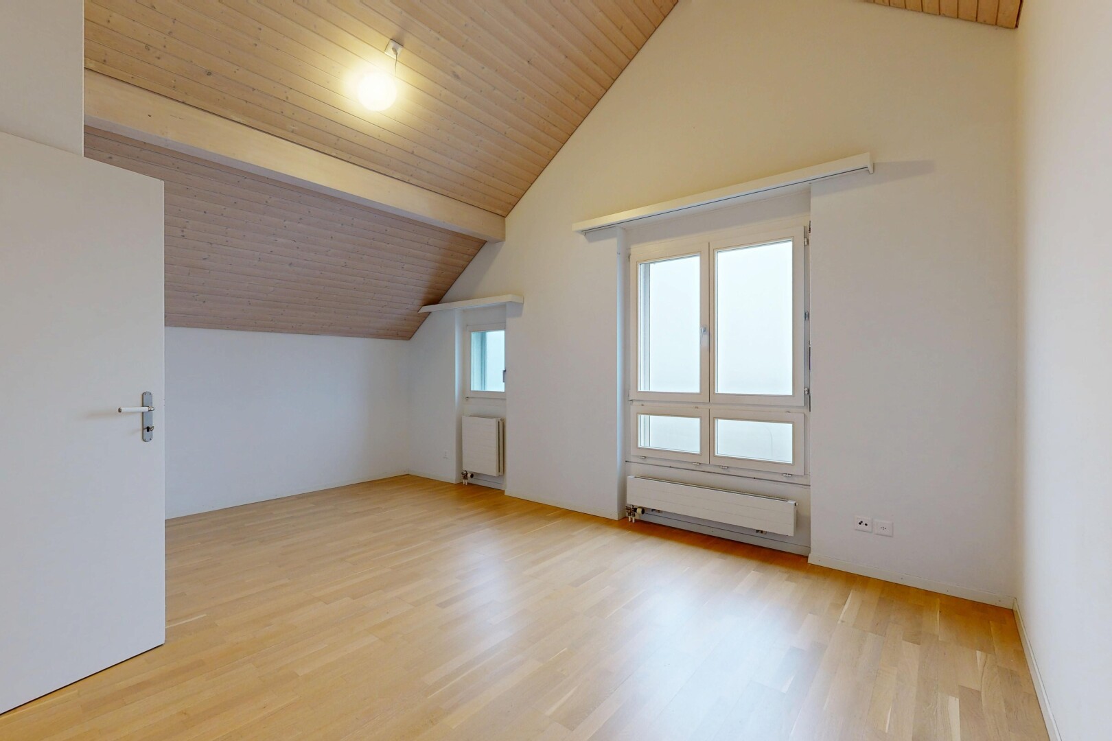 empty room with wood ceiling, light wood-type flooring, and radiator heating unit