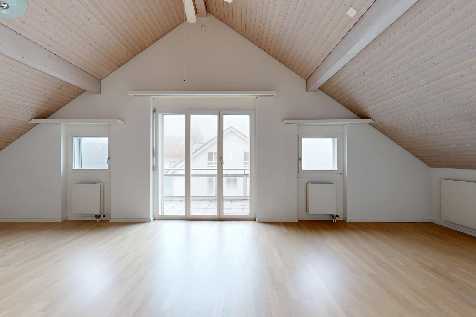 spare room featuring light wood-style floors, plenty of natural light, radiator heating unit, and wooden ceiling