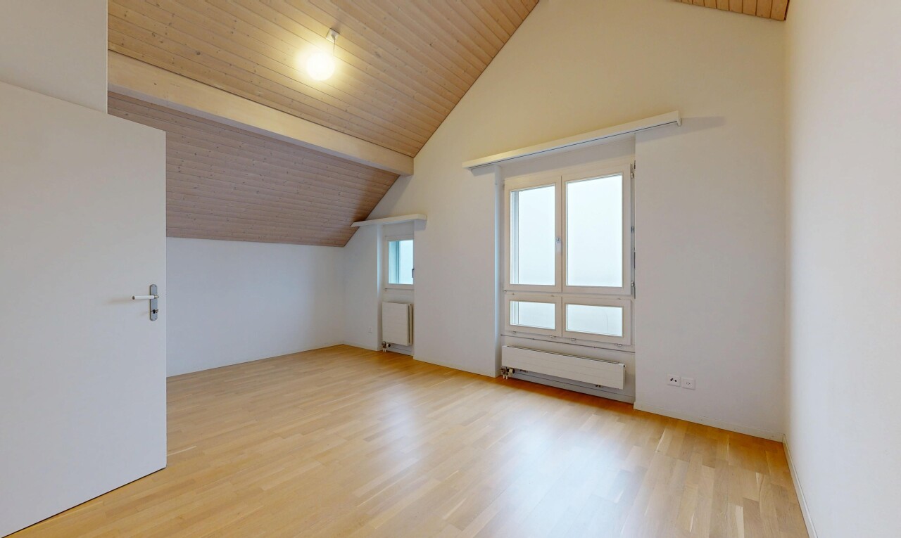 empty room with wood ceiling, light wood-type flooring, and radiator heating unit
