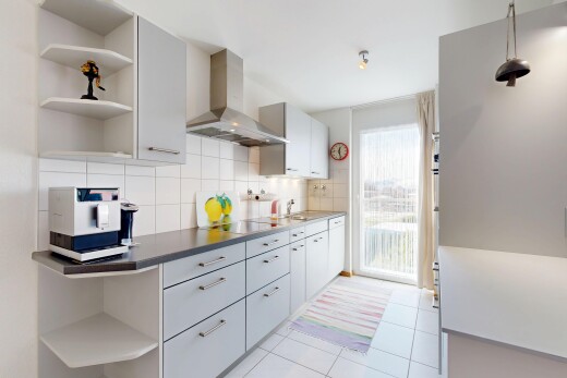 kitchen featuring open shelves, wall chimney exhaust hood, tasteful backsplash, and light tile patterned floors