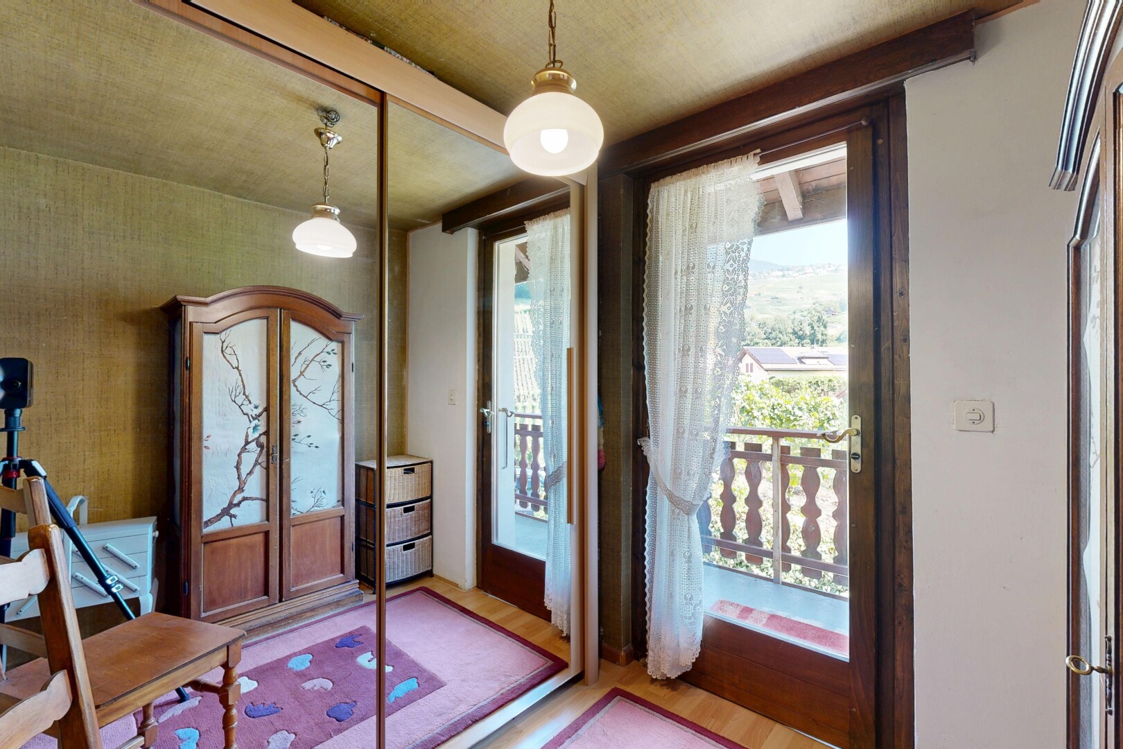 chambre avec éclairage suspendu, accès à l'extérieur, sol en finition bois, wood finish floor, et inside property