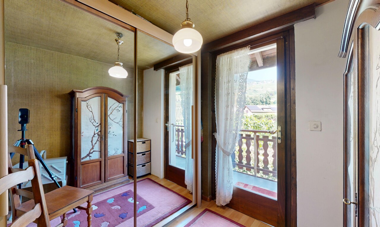 chambre avec éclairage suspendu, accès à l'extérieur, sol en finition bois, wood finish floor, et inside property