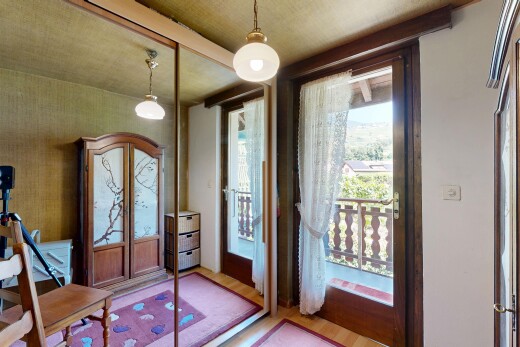 chambre avec éclairage suspendu, accès à l'extérieur, sol en finition bois, wood finish floor, et inside property