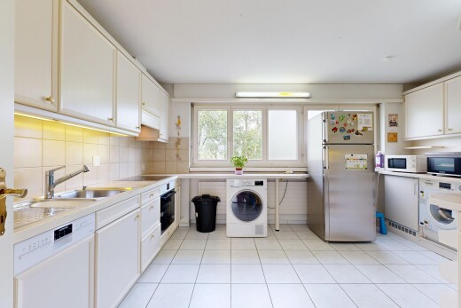 kitchen with stainless steel appliances, washer / dryer, white cabinets, backsplash, and light tile patterned floors