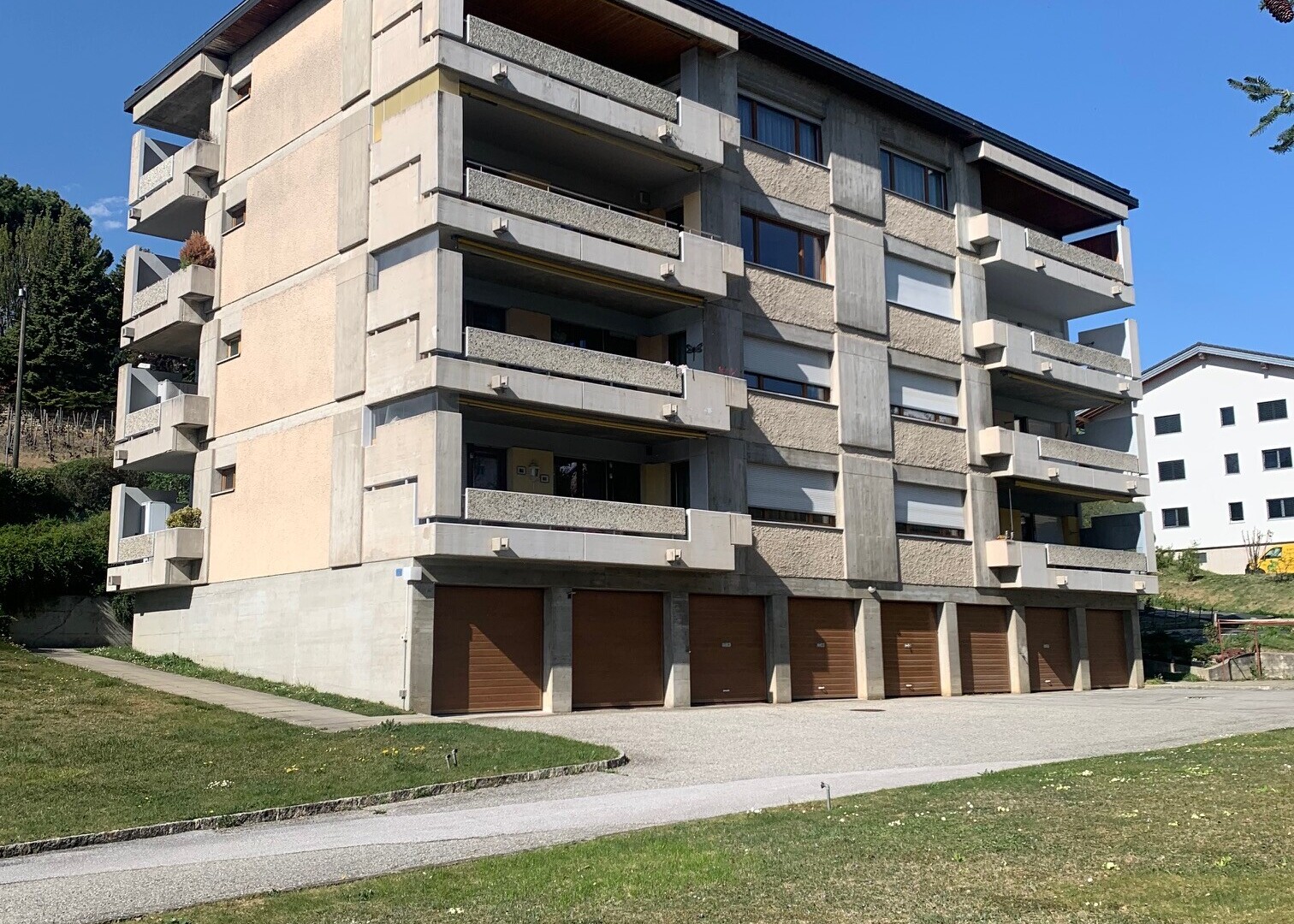 view of apartment building / complex with community garages
