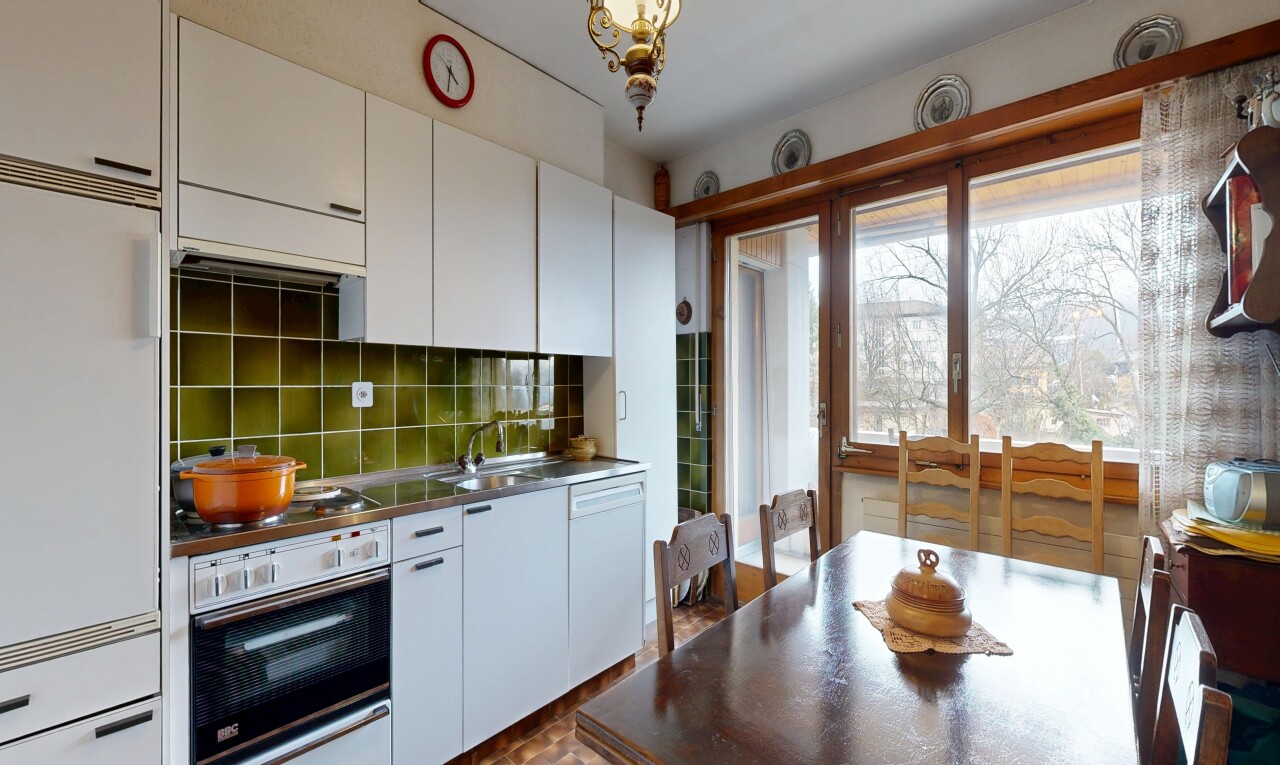 kitchen with wall oven, white cabinetry, built in fridge, and dark countertops