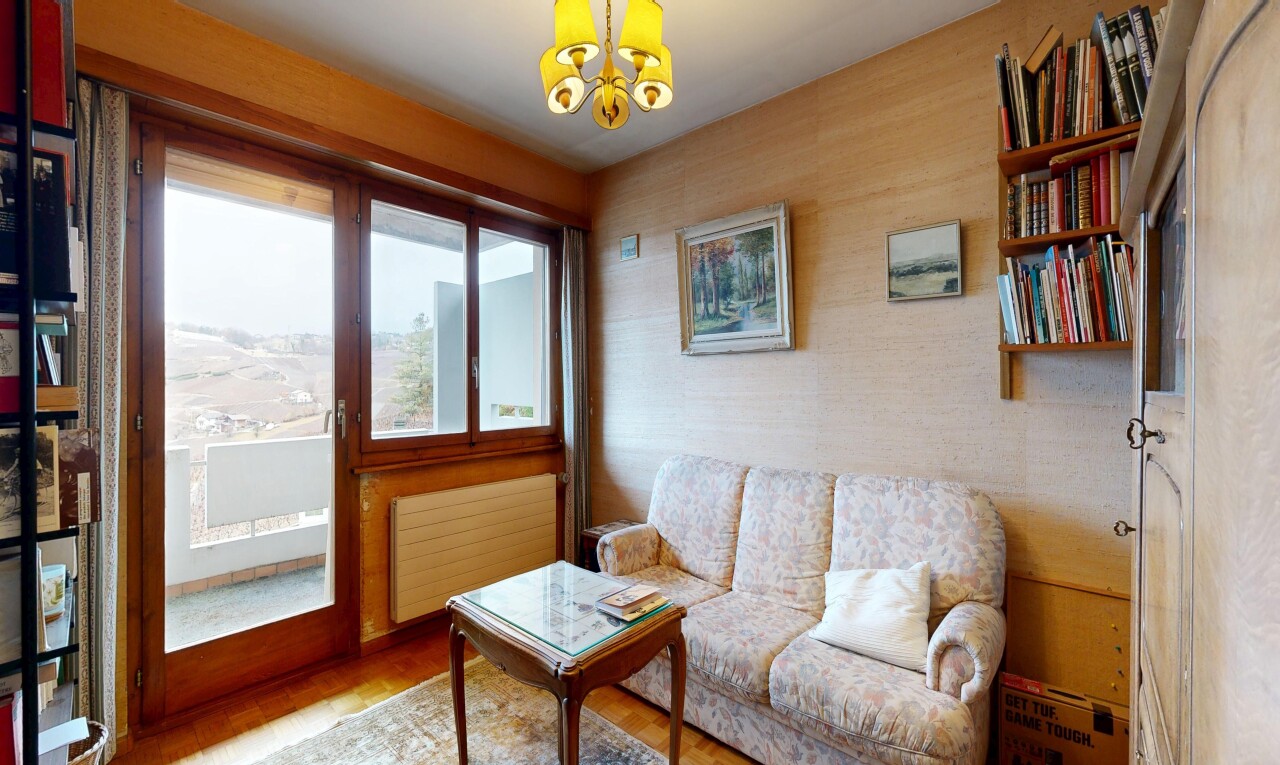 living area featuring radiator, hanging lights, and wood finished floors