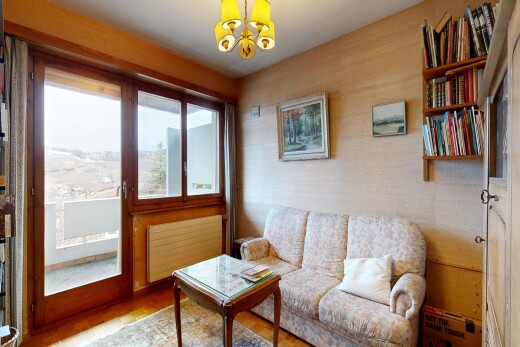 living area featuring radiator, hanging lights, and wood finished floors