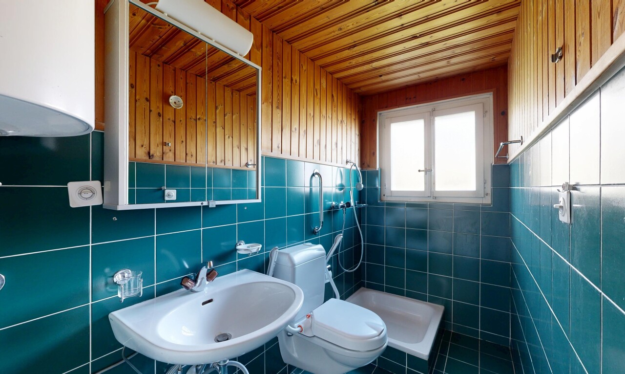 full bath with a shower stall and tile walls