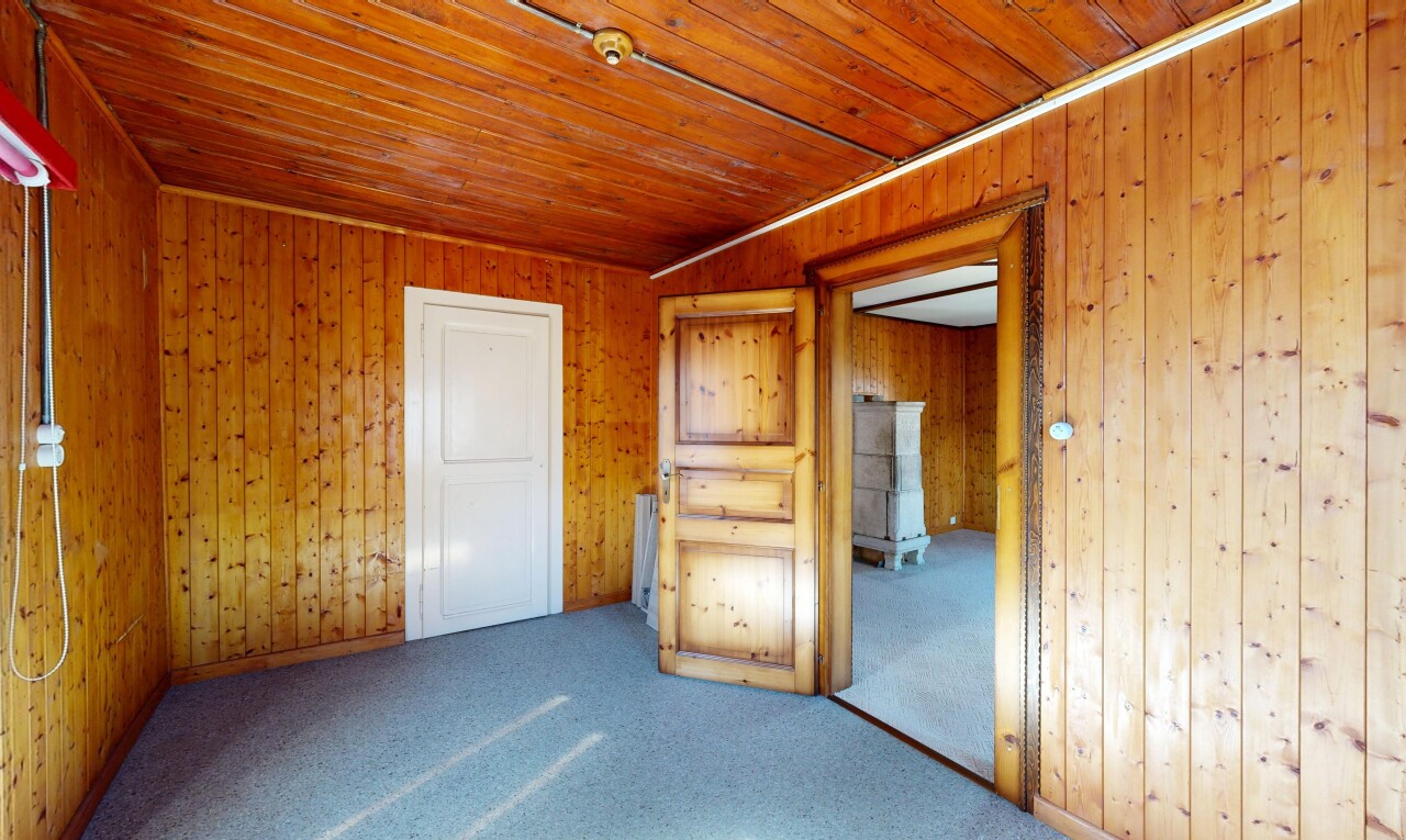 spare room featuring carpet flooring, wood ceiling, and wood walls