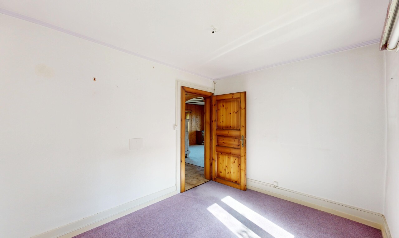 spare room featuring carpet flooring and baseboards