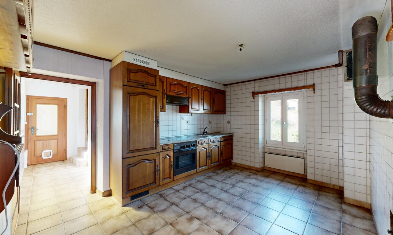 kitchen with wood finish cabinetry, black oven, crown molding, and light countertops