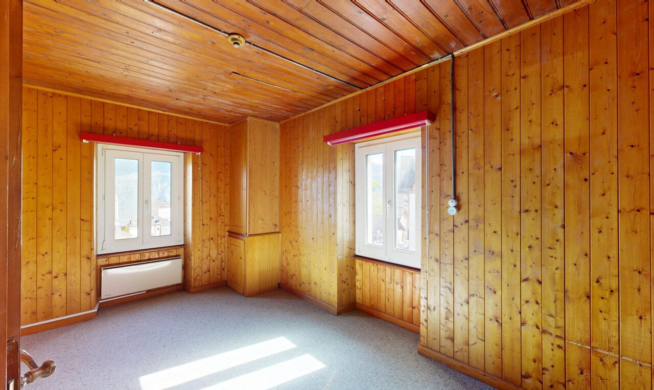 empty room with wooden ceiling and carpet
