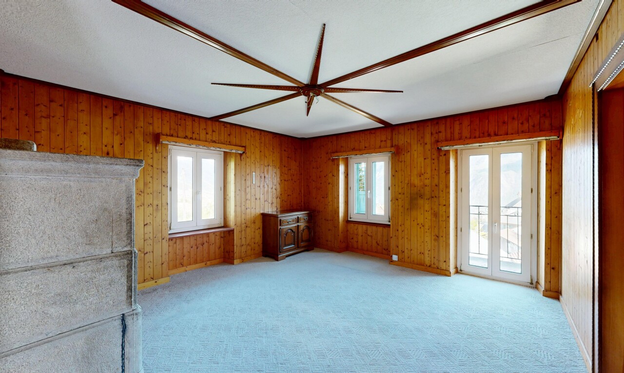 unfurnished room featuring light carpet and wood walls