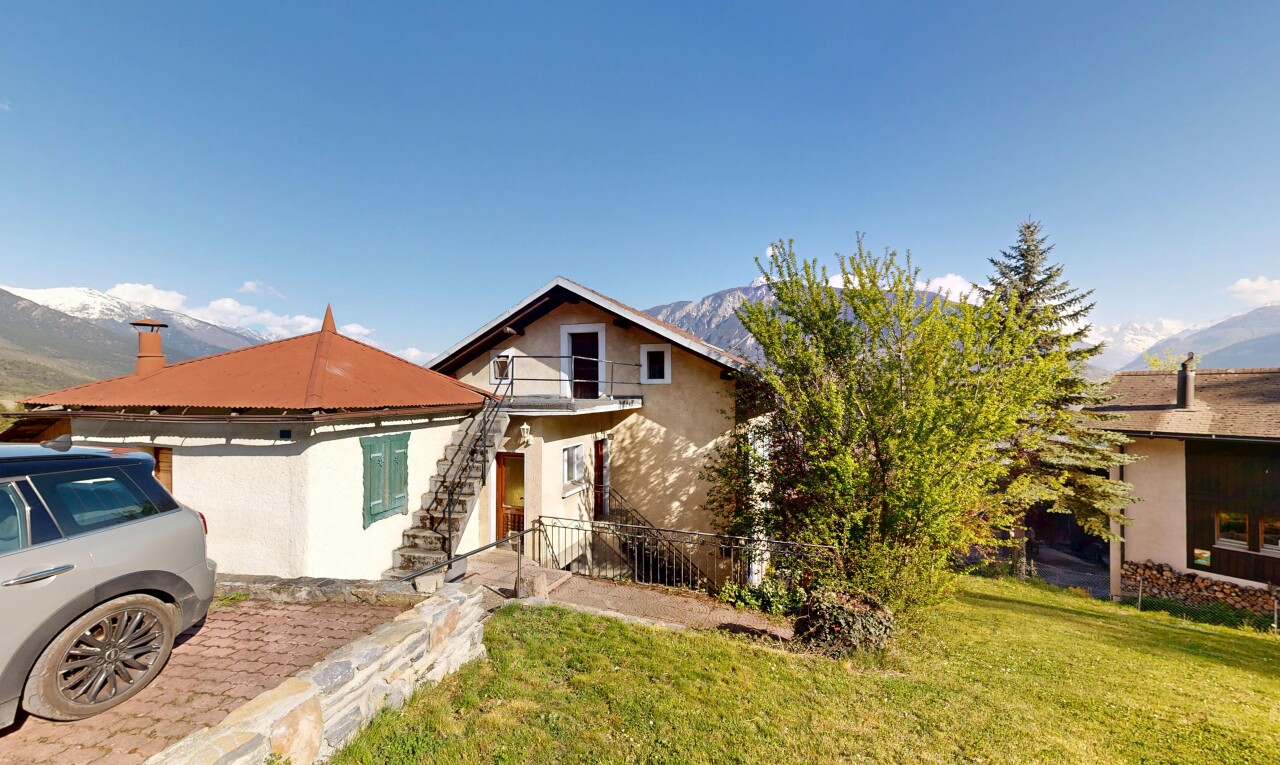 view of property with stucco siding, a lawn, and a balcony